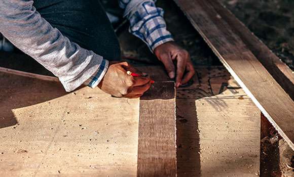 contractor measuring to cut wood